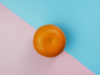 Creative concept made from orange on blue and pink pastel background. healthy and minimal fruit concept