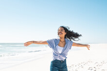 Carefree Smiling Woman Enjoy The Summer At Beach