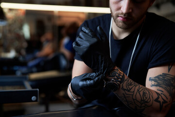 Sticker - Caucasian owner of a tattoo studio wearing disposable gloves