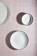 Wall Mural - white empty plates kitchen pink tile background, ceramic. place for text.