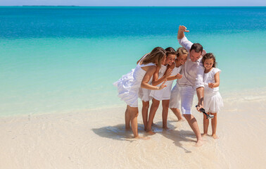 Wall Mural - Happy Caucasian family selfie photo on Caribbean beach