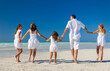 © Spotmatik - Caucasian family enjoying leisure walking on tropical beach