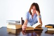 © TenWit - A white caucasian young teen student sitting at a table reading books looking bored