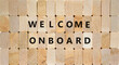 Welcome onboard and support symbol. Concept words Welcome onboard on wooden blocks on a beautiful wooden background, copy space. Business and Welcome onboard concept.