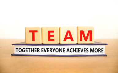 Wall Mural - TEAM together everyone achieves more symbol. Concept words TEAM together everyone achieves more on cubes. White background. Business, motivational TEAM together everyone achieves more concept.