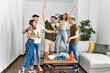 © Krakenimages.com - Group of young friends smiling happy and dancing at home.