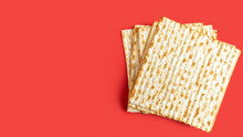 Matzah For Jewish Holiday Pesach On Red Background.