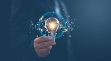 Hand Of Businessman Holding Illuminated Light Bulb With Network Connection Line, Idea, Innovation And Inspiration Concept. Concept Creativity With Bulbs That Shine Glitter.