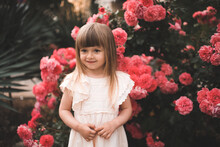 Blonde Girl Posing With Pink Rose Flower Tree