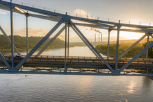 Gray Metal Train Bridge Over River At Sunset