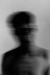 © Scopio - Grayscale blurry portrait of topless man against light background