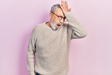 Poster - Handsome senior man with beard wearing casual sweater and glasses surprised with hand on head for mistake, remember error. forgot, bad memory concept.