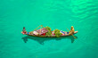 © Scopio - Top view of mother and daughter sitting on a boat selling fresh produce in Bangladesh
