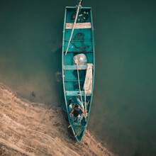 Top View Of Man On Blue Boat