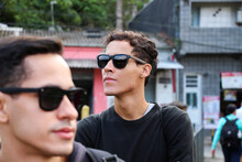Two Young Men In Sunglasses Standing On Street
