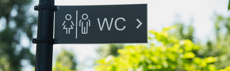 water closet direction sign outdoors, banner.