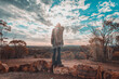 © Scopio - Woman watching sunset over outback desert