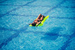 © Дмитрий Ткачук - Young sexy wman in a swimsuit swims in the pool on an inflatable mattress. Girl in sunglasses in a blue pool on vacation