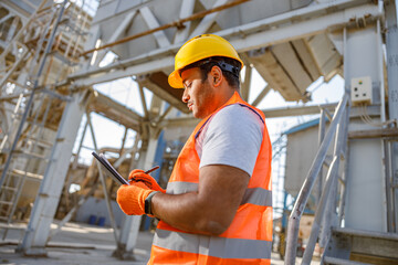 Photo of man working hard on location site