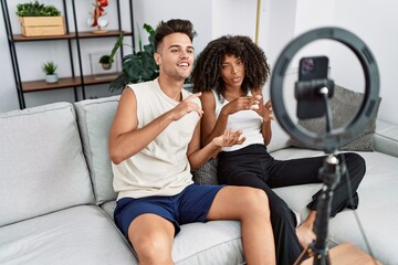 Canvas Print - Man and woman couple using smartphone having video call at home