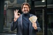 © Krakenimages.com - Handsome middle age man holding 100 danish krone banknotes doing ok sign with fingers, smiling friendly gesturing excellent symbol