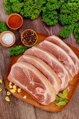 Wall Mural - Sliced raw pork shoulder with spices on wooden board.