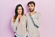 Young hispanic couple wearing casual clothes touching painful neck, sore throat for flu, clod and infection