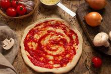 Pizza And Sauce Homemade Cooking With Ingredients On Table. Dough Pizza At Tabletop
