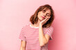 © Asier - Young caucasian woman isolated on pink background who is bored, fatigued and need a relax day.