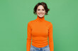 Young smiling happy caucasian fun satisfied cheerful woman 20s in casual orange turtleneck look camera isolated on plain pastel light green color background studio portrait. People lifestyle concept