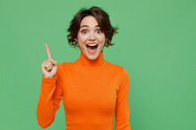 Young Smiling Insighted Smart Fun Proactive Woman 20s Wear Casual Orange Turtleneck Holding Index Finger Up With Great New Idea Isolated On Plain Pastel Light Green Color Background Studio Portrait
