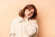 © Asier - Young caucasian woman isolated on beige background who is bored, fatigued and need a relax day.