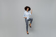 Full body overjoyed excited fun happy young employee business corporate lawyer woman of African American ethnicity in classic formal shirt work in office do winner gesture isolated on grey background.