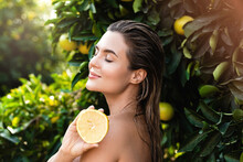 Beautiful Woman With Smooth Skin With A Lemon Fruit In Her Hands