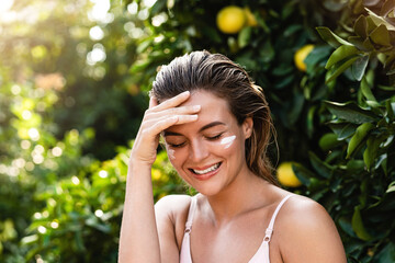 Wall Mural - beautiful woman with moisturizing cream under her eyes