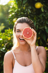 Wall Mural - beautiful woman with smooth skin with a grapefruit in her hands
