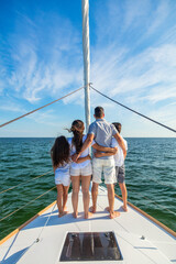 Wall Mural - Young Hispanic family standing together on luxury yacht