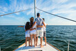 © Spotmatik - Young Latino family standing together on private yacht