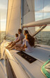© Spotmatik - Latin American family relaxing on yacht at sunset