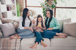 © deagreez - Full body photo of mommy and girls look read browse cellphone social network post sitting couch flat indoors
