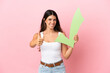 Young caucasian woman isolated on pink background holding a check icon with thumb up