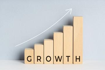 Wall Mural - Growth concept. Wooden block bar chart graph with text and upward trend line drawn on background. Copy space