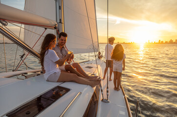 Hispanic family relaxing on luxury yacht at sunset