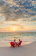 © Spotmatik - Retired Caucasian couple on beach at sunset Bahamas