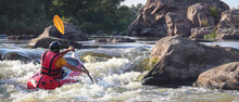 A Man Rowing Inflatable Packraft On Whitewater Of Mountain River. Concept: Summer Extreme Water Sport, Active Rest, Extreme Rafting.