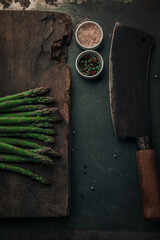 Wall Mural - rustic picture with fresh asparagus on top of chopping board