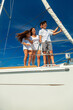 © Spotmatik - Smiling Latino family on yacht travelling the ocean