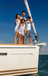 © Spotmatik - Smiling Latin American family waving from private yacht