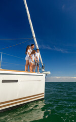 Wall Mural - Hispanic family enjoying vacation together on private yacht