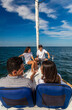 © Spotmatik - Successful young Latino family sitting on private yacht